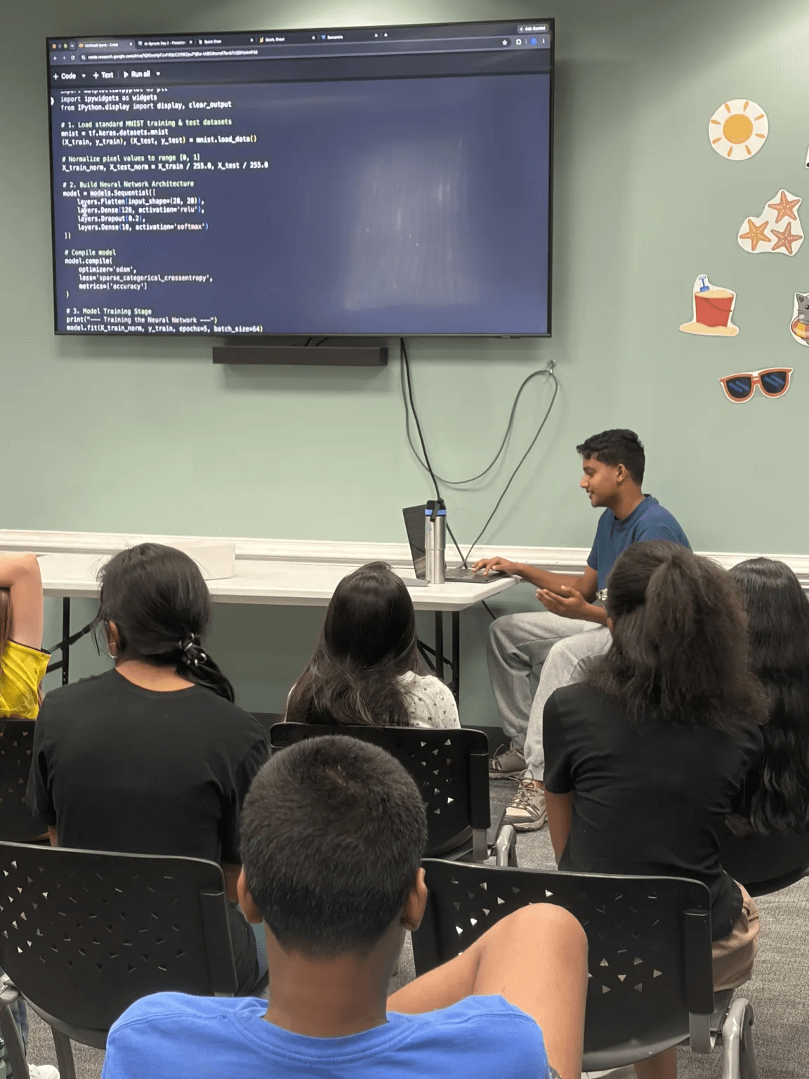 A young instructor explaining an AI model to students